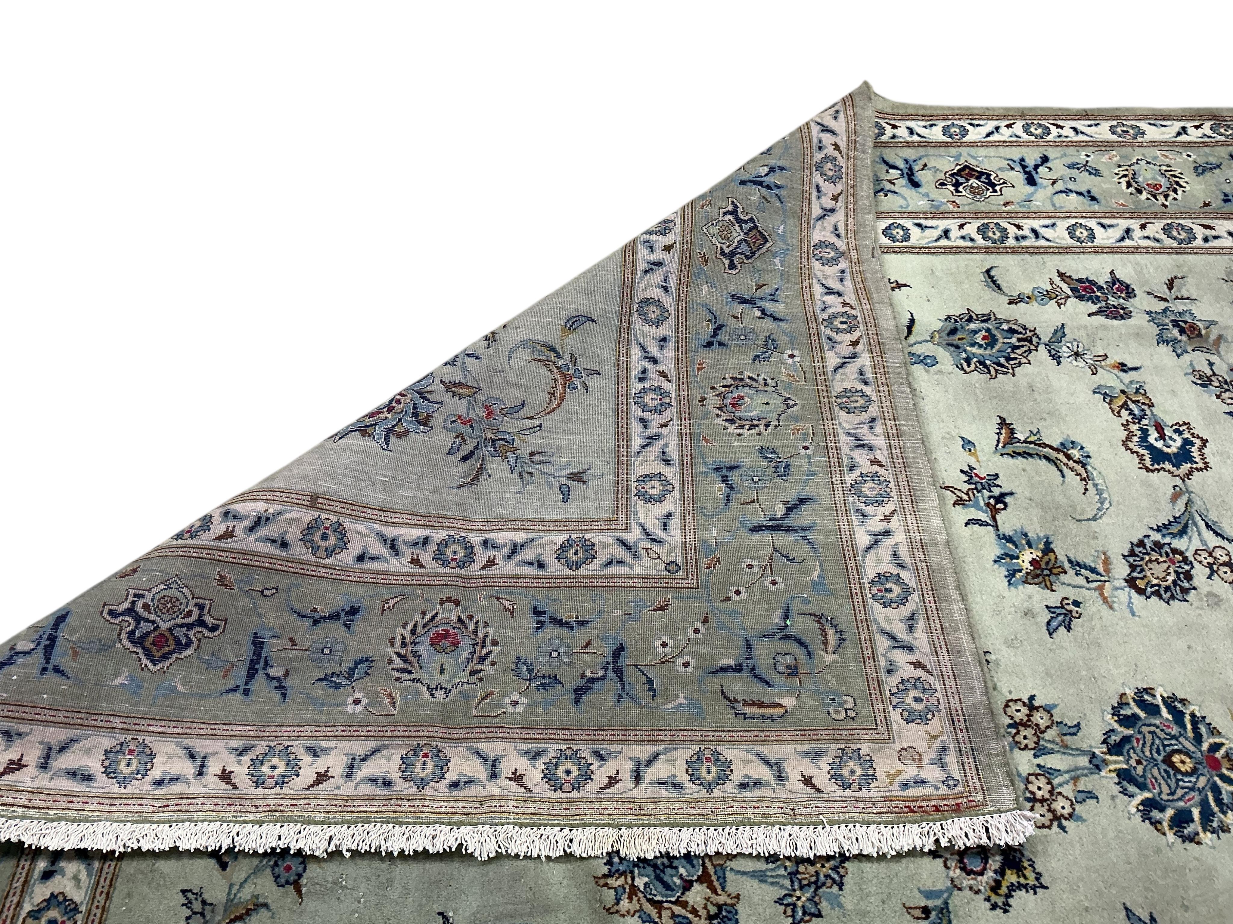 A Kashan pale green ground carpet, 380 x 260cm